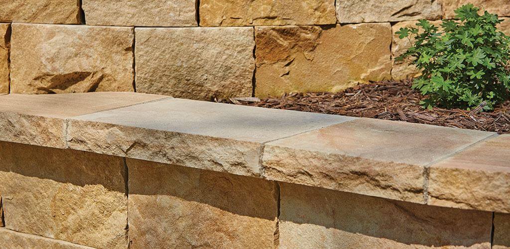 Harvest Gold Sandstone caps are shown atop a small retaining wall.