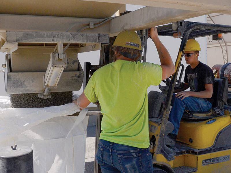 Kafka employees loading super sacks of material