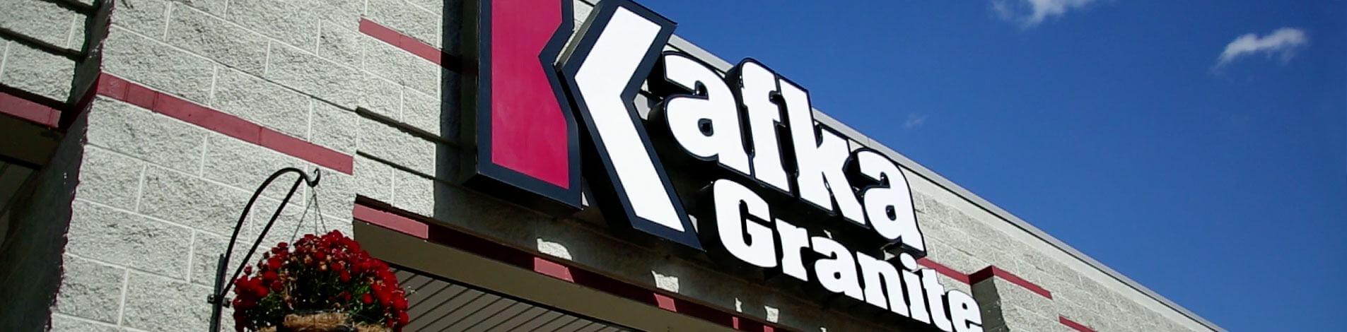 A sign featuring the logo of Kafka Granite hangs above the Kafka Granite office.