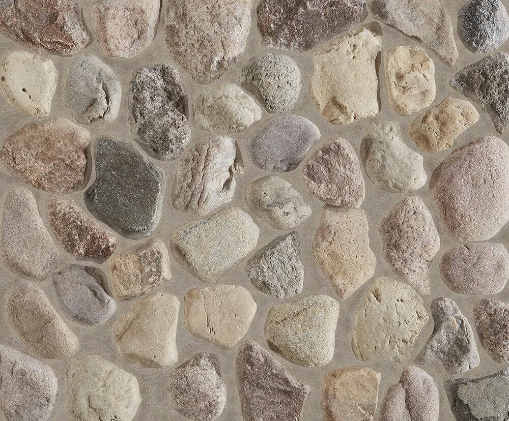 A close up of a stone facade with rounded Wisconsin Fieldstone