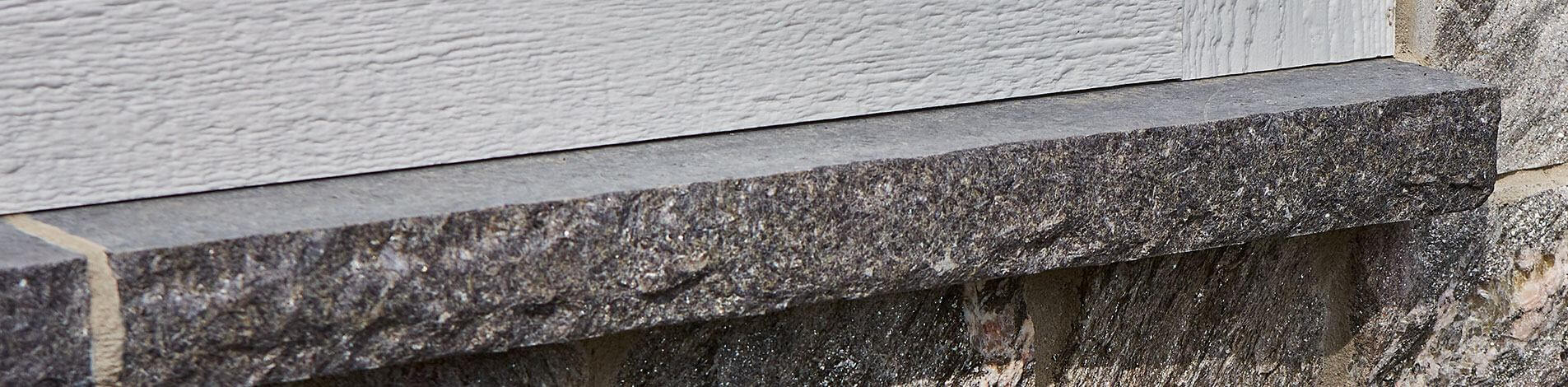 A closeup of a Starlight Black Granite sill.