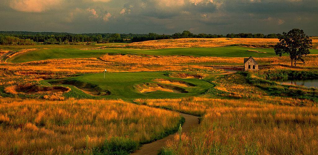 A gorgeous photo of the Erin Hills course course cloaked in rich amber light.