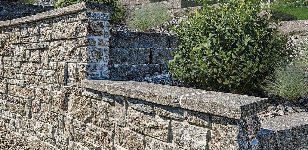 Beautiful retaining walls are shown in dimensional cut Galaxy Glitter Thing Stone Veneer.