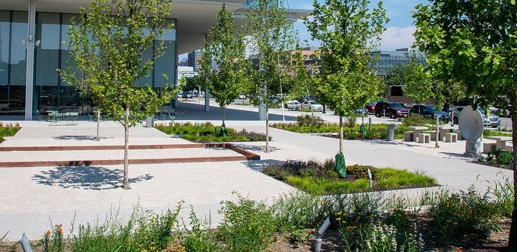 The grounds of Krause Gateway Center Plaza are shown, with beautiful stabilized pathway mix between the garden beds.