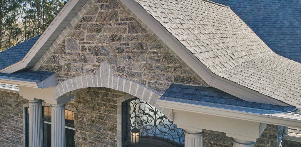Beautiful stonework on the peak above an entryway to a home.