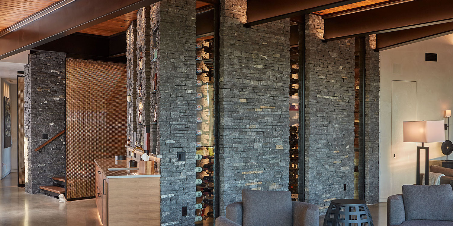 Kafka's Starlight Black Ledgestone Thin Stone Veneer featured in a custom wine cellar and accent walls