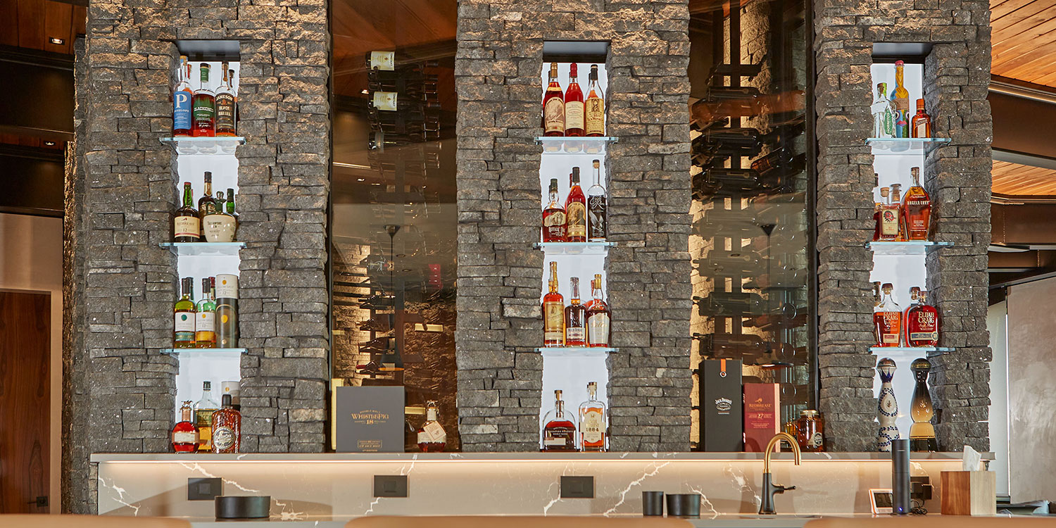 Kafka's Starlight Black Ledgestone Thin Stone Veneer featured in a custom wine cellar and accent walls